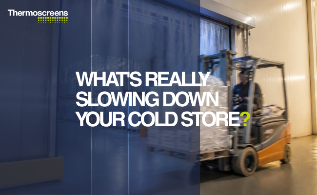 Forklift passing through a cold storage warehouse doorway protected by a cold store air curtain